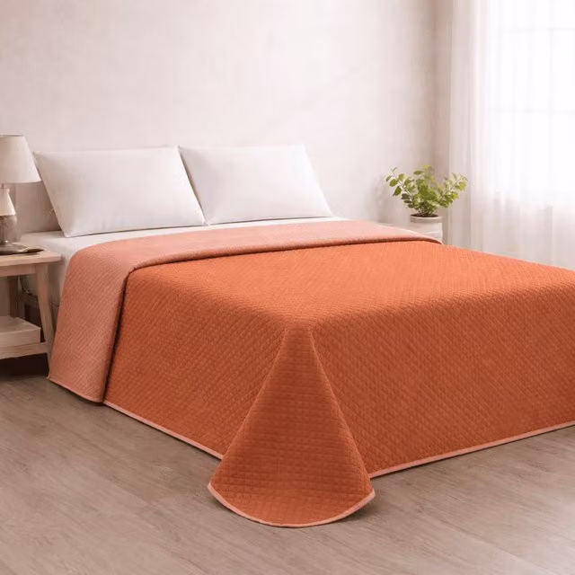 Colcha reversible acolchada Donegal Collections en color naranja teja/coral para cama de 105 cm