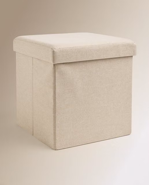 Caja puf El Corte Inglés de tela beige con diseño moderno y acabado mate