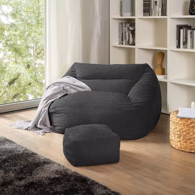 Puf Home Deluxe COZY con taburete en color antracita y acabado de terciopelo o pana para tu salón