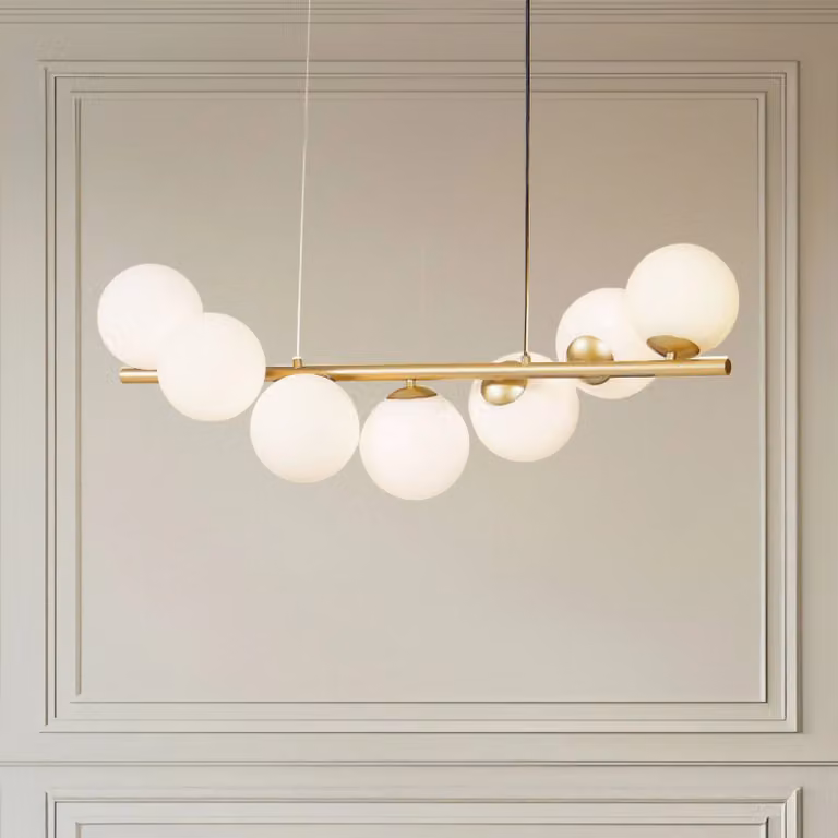 Lámpara colgante de cristal Isandro de Lucande, diseño atenuable en latón y oro con detalles en vidrio para salón o comedor